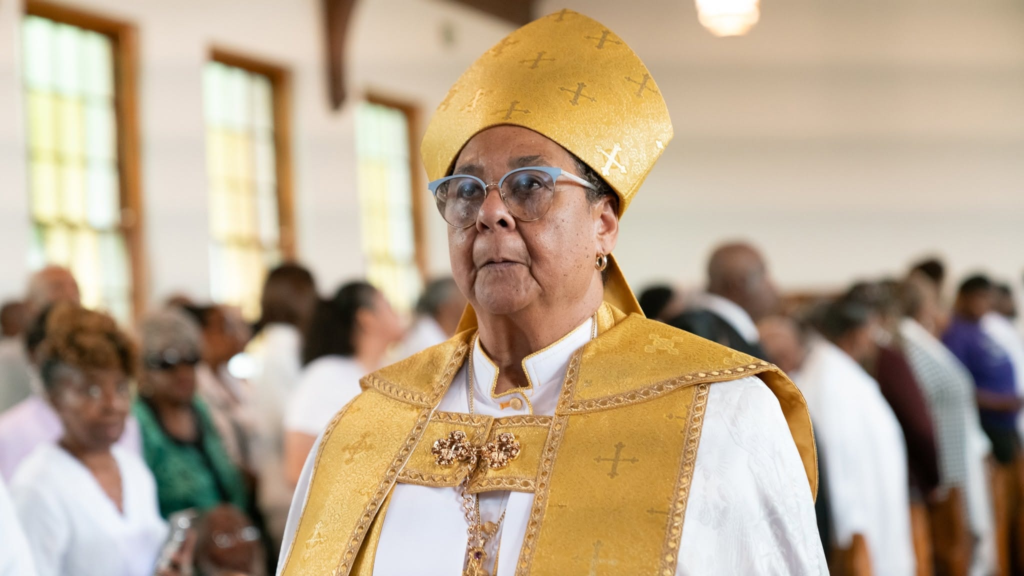 Robed in gold — a bishop in full regalia walks the sanctuary